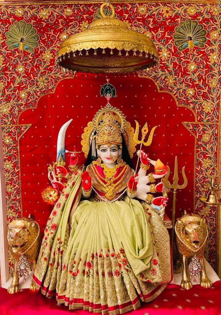 Ambe Maa seated on throne with lions