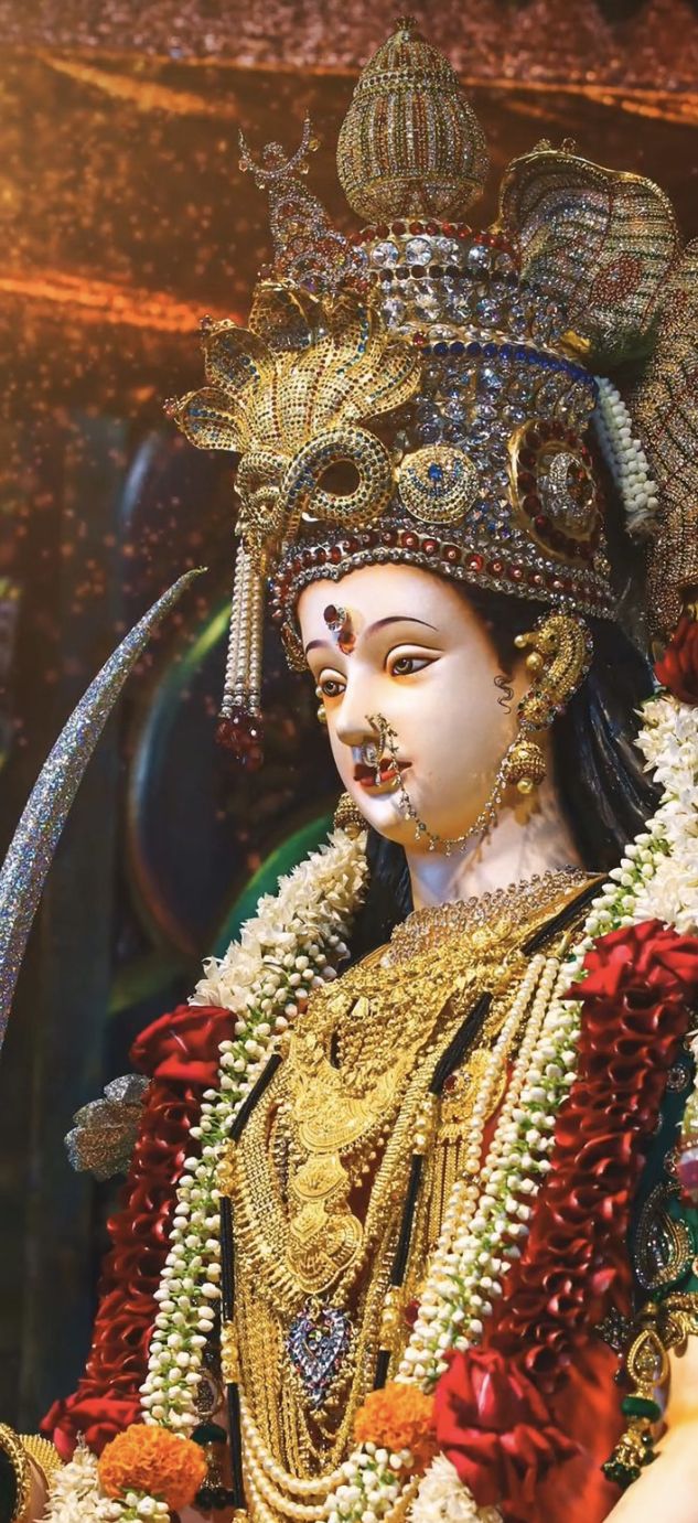 Close-up of Ambe Maa with gold jewelry