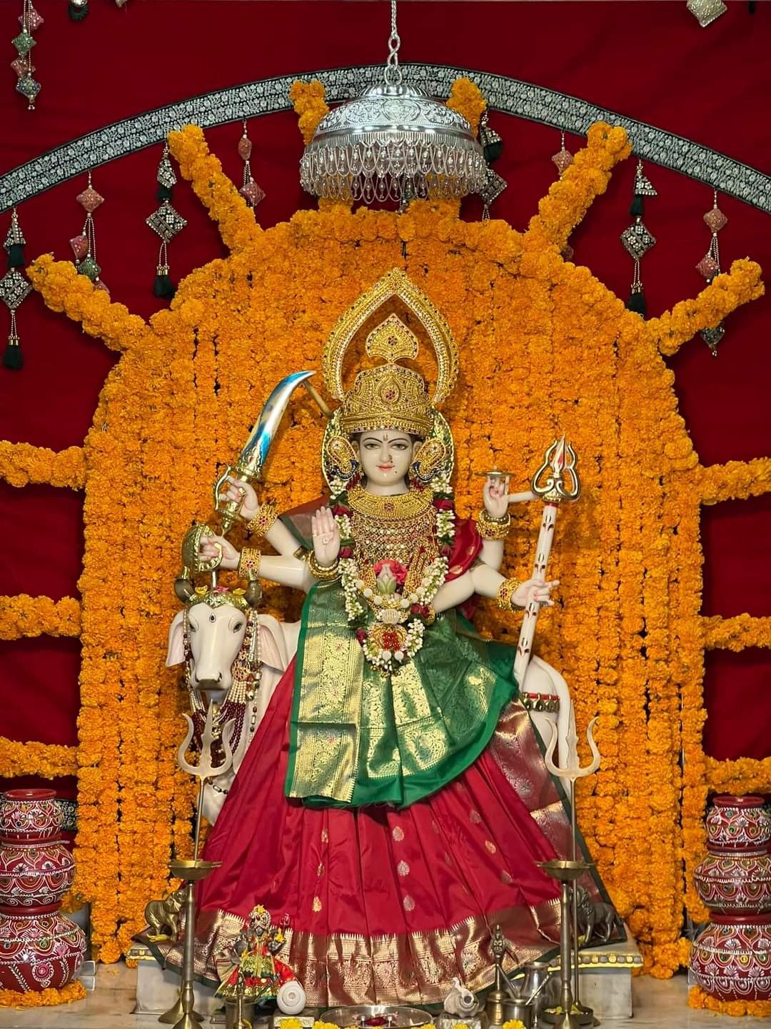 Ambe Maa adorned with marigold flowers.