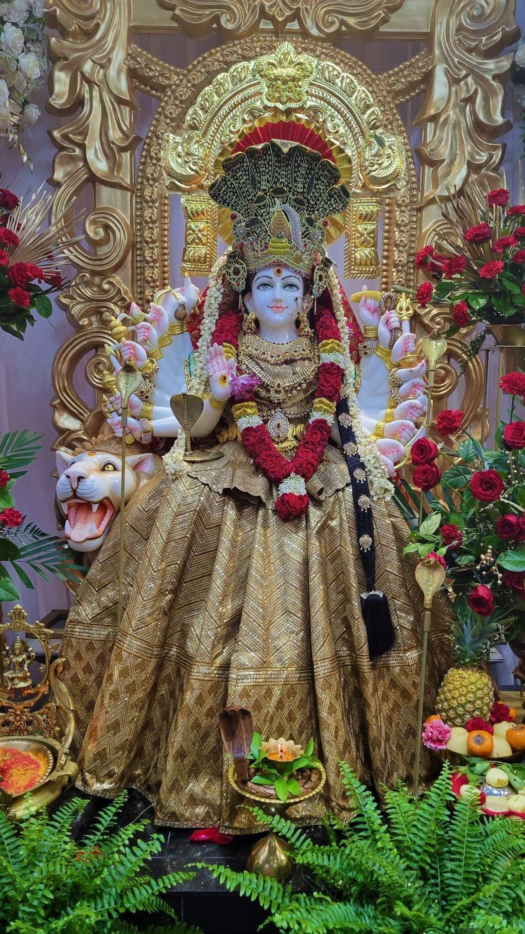 Ambe Maa with lion, flowers, and gold.