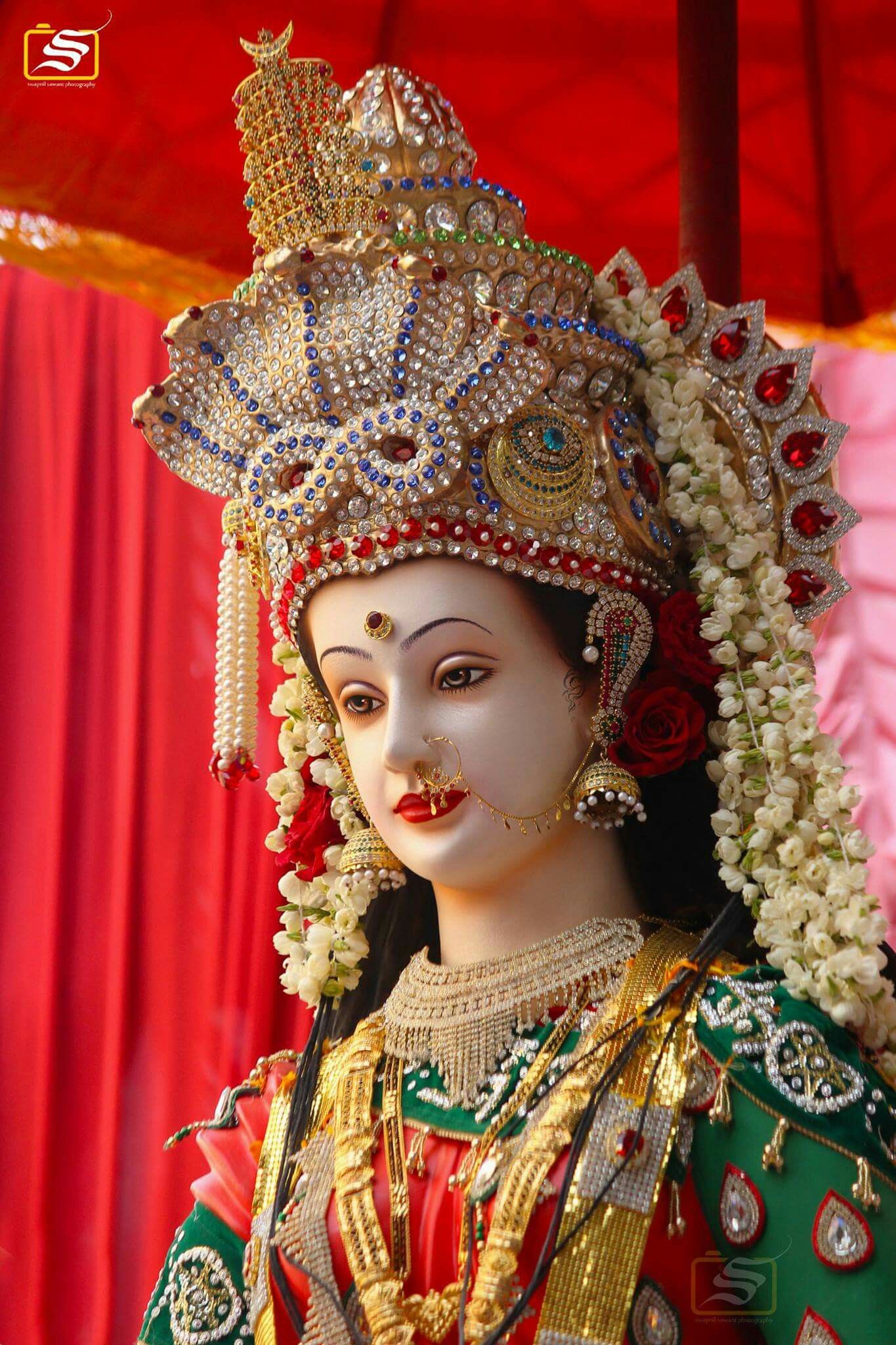 Close-up of Ambe Maa with floral adornments