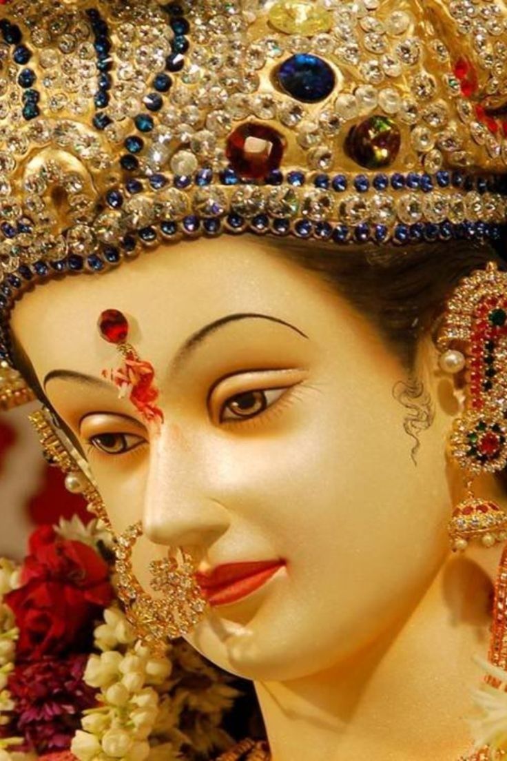 Close-up of Ambe Maa\'s radiant face.