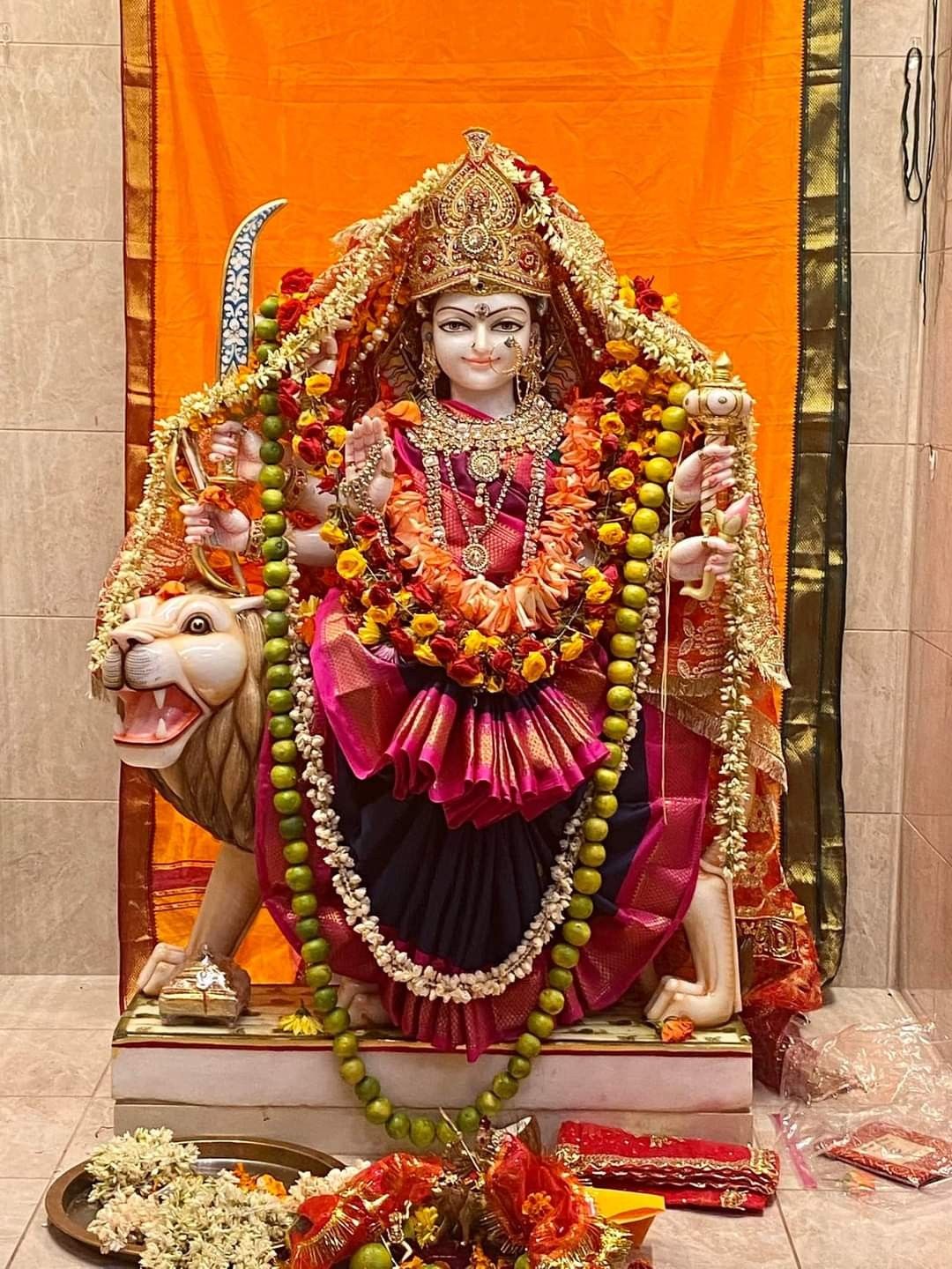 Ambe Maa statue with lion, divine protector.