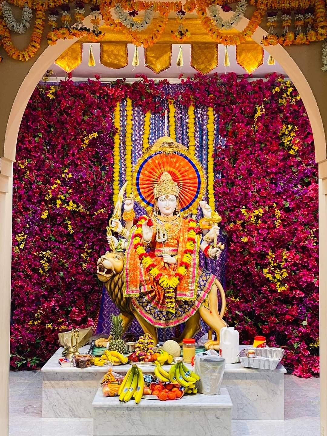 Ambe Maa seated on a lion, floral temple
