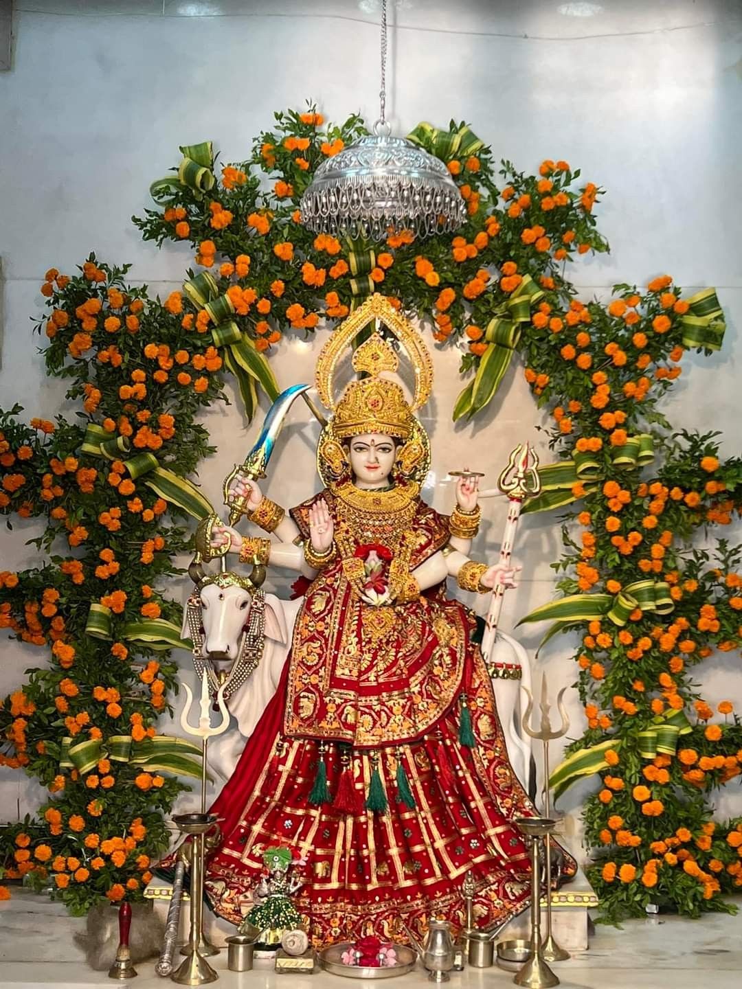 Ambe Maa seated amidst floral decorations