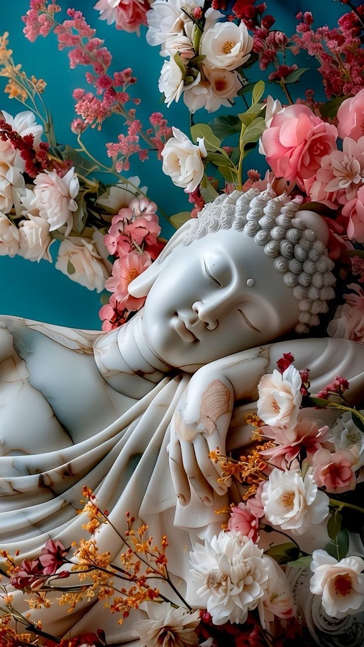Buddha statue adorned with pink flowers