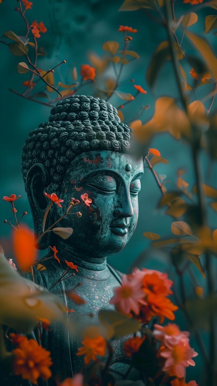 Buddha statue among vibrant floral blooms