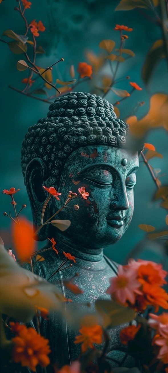 Buddha\'s peaceful face amongst orange flowers