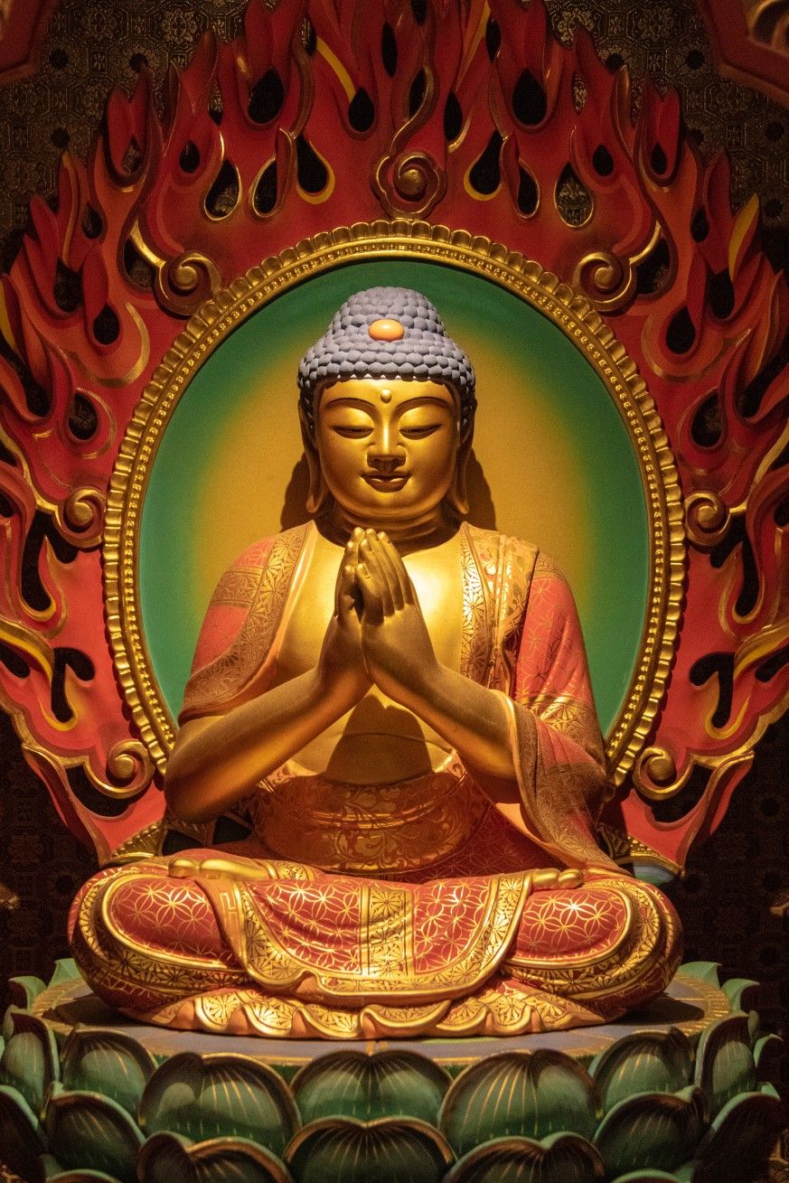 Golden buddha meditating in lotus position.