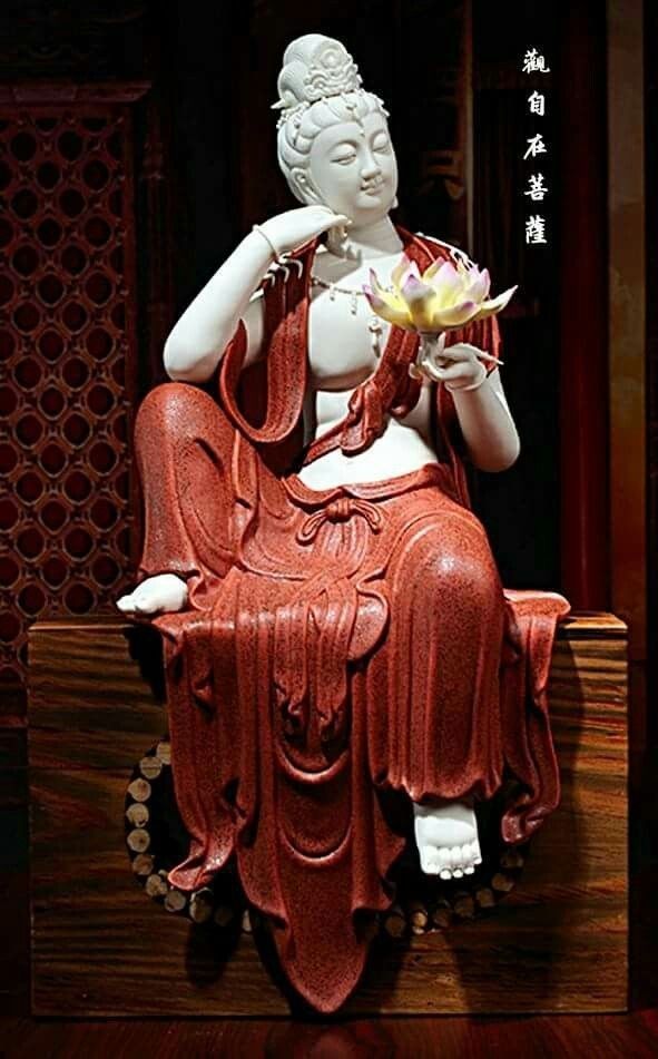 Buddha statue holding a lotus flower.