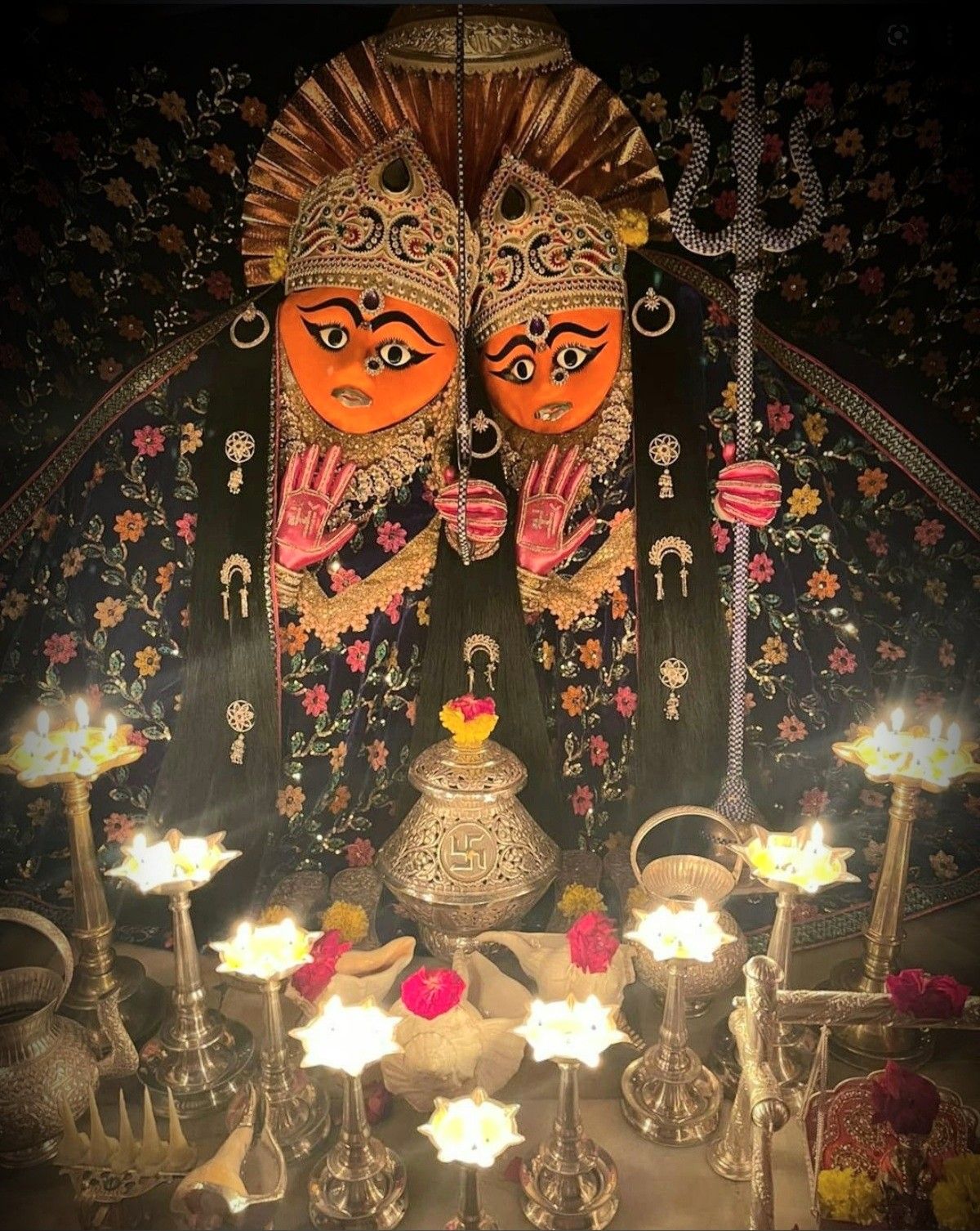 Two-faced Chamunda Maa with oil lamps