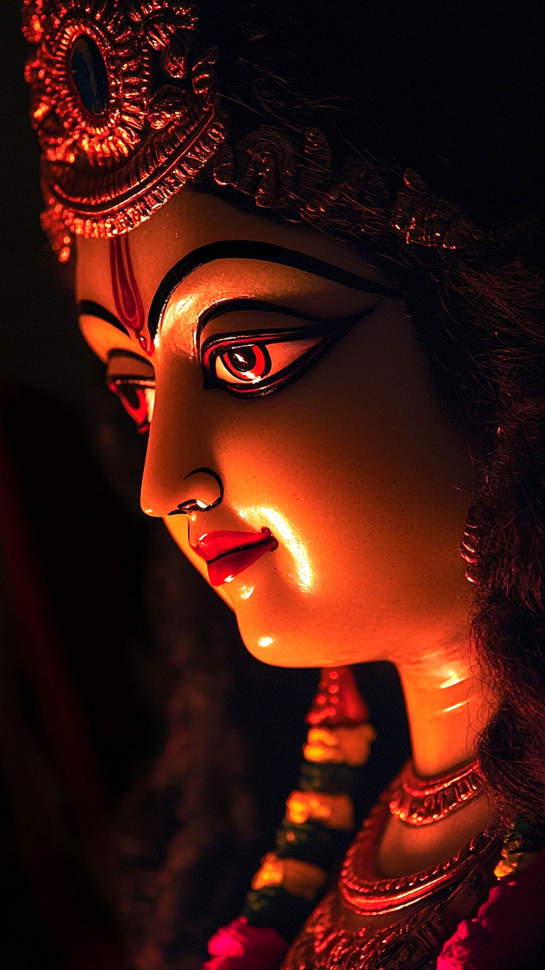 Durga Maa\'s captivating face in crimson light