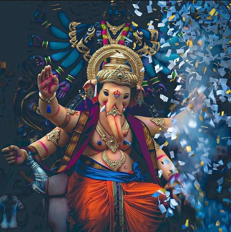 Lord Ganesha showered with colorful confetti