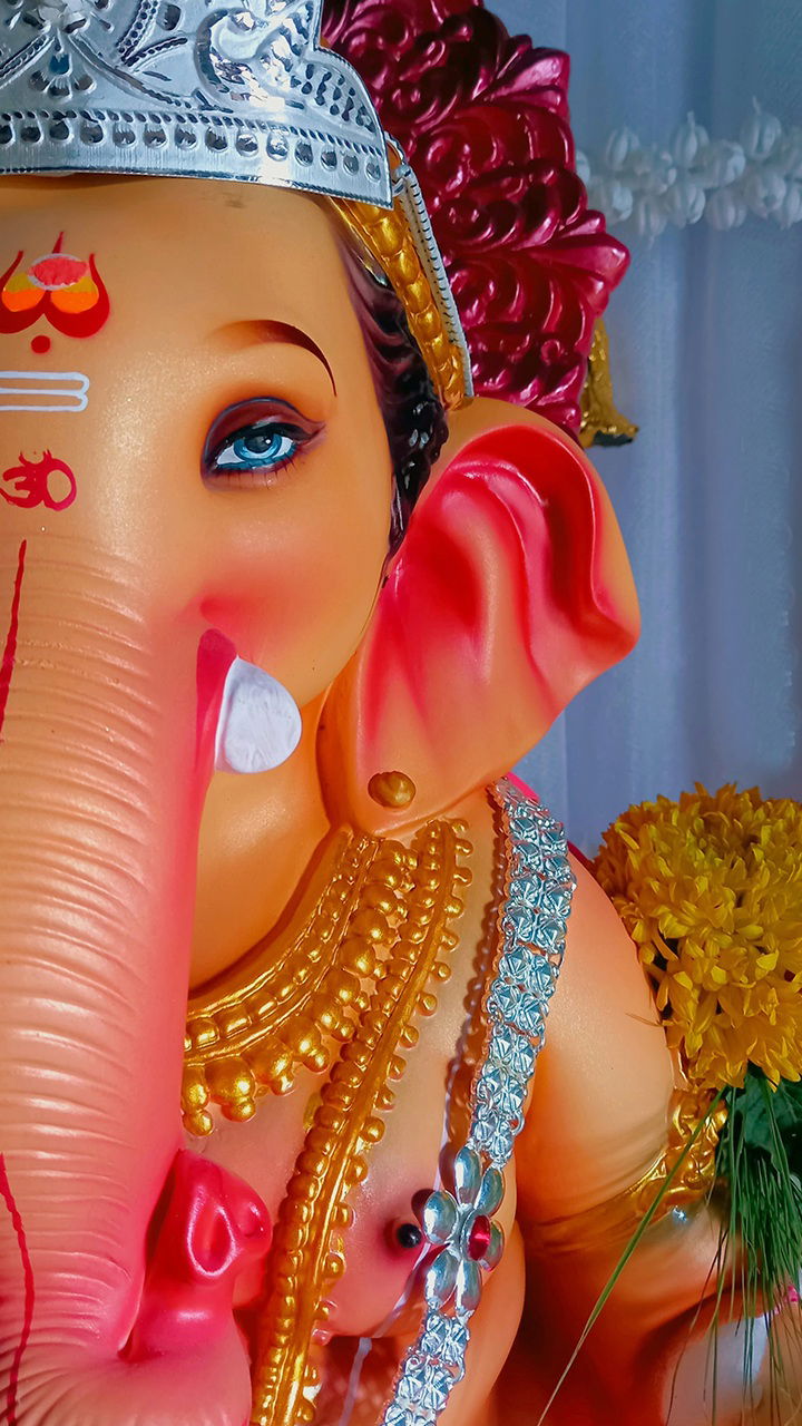 Close-up of Ganesha with blue eyes.