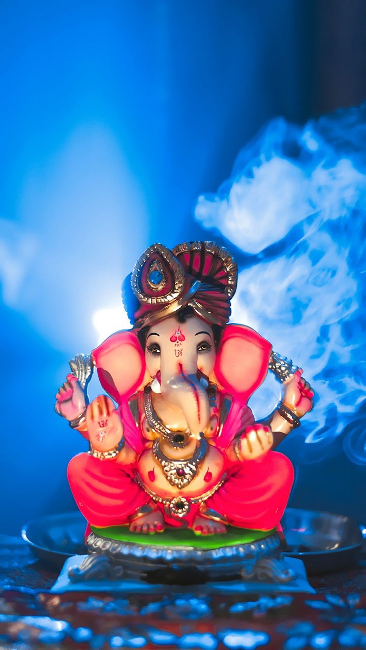 Ganesha statue with incense smoke
