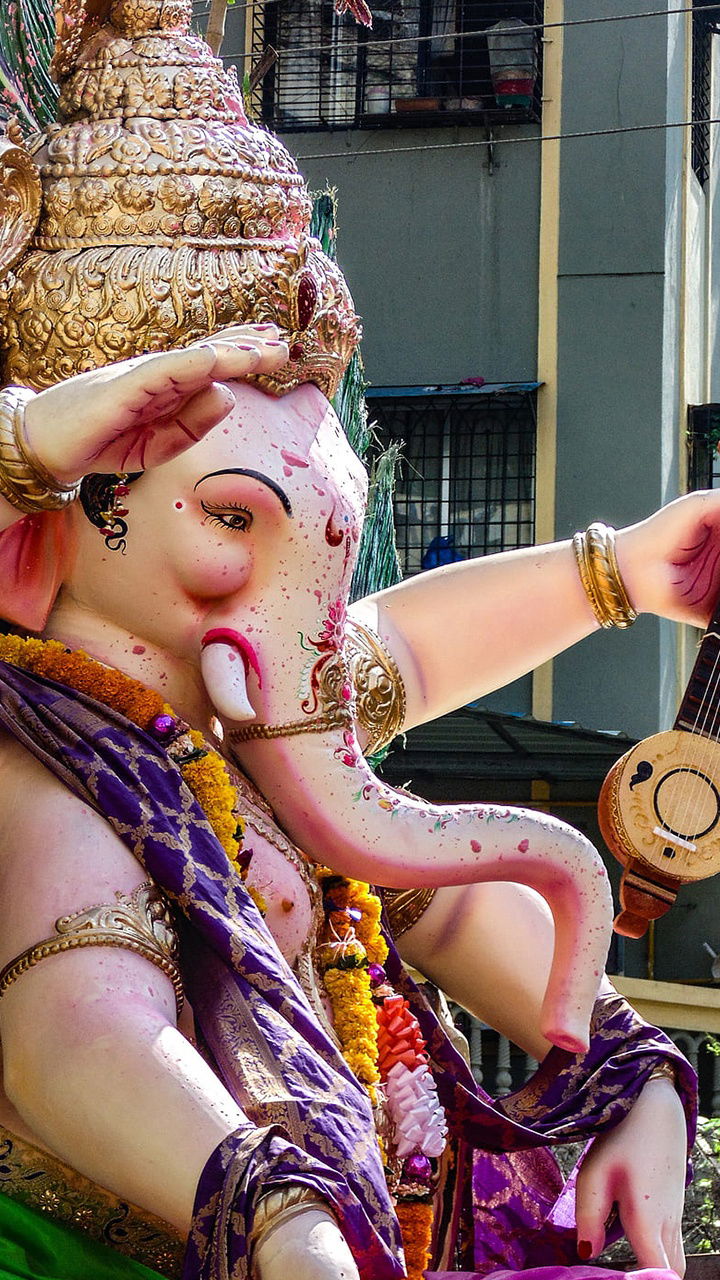 Lord Ganesha playing a santoor instrument
