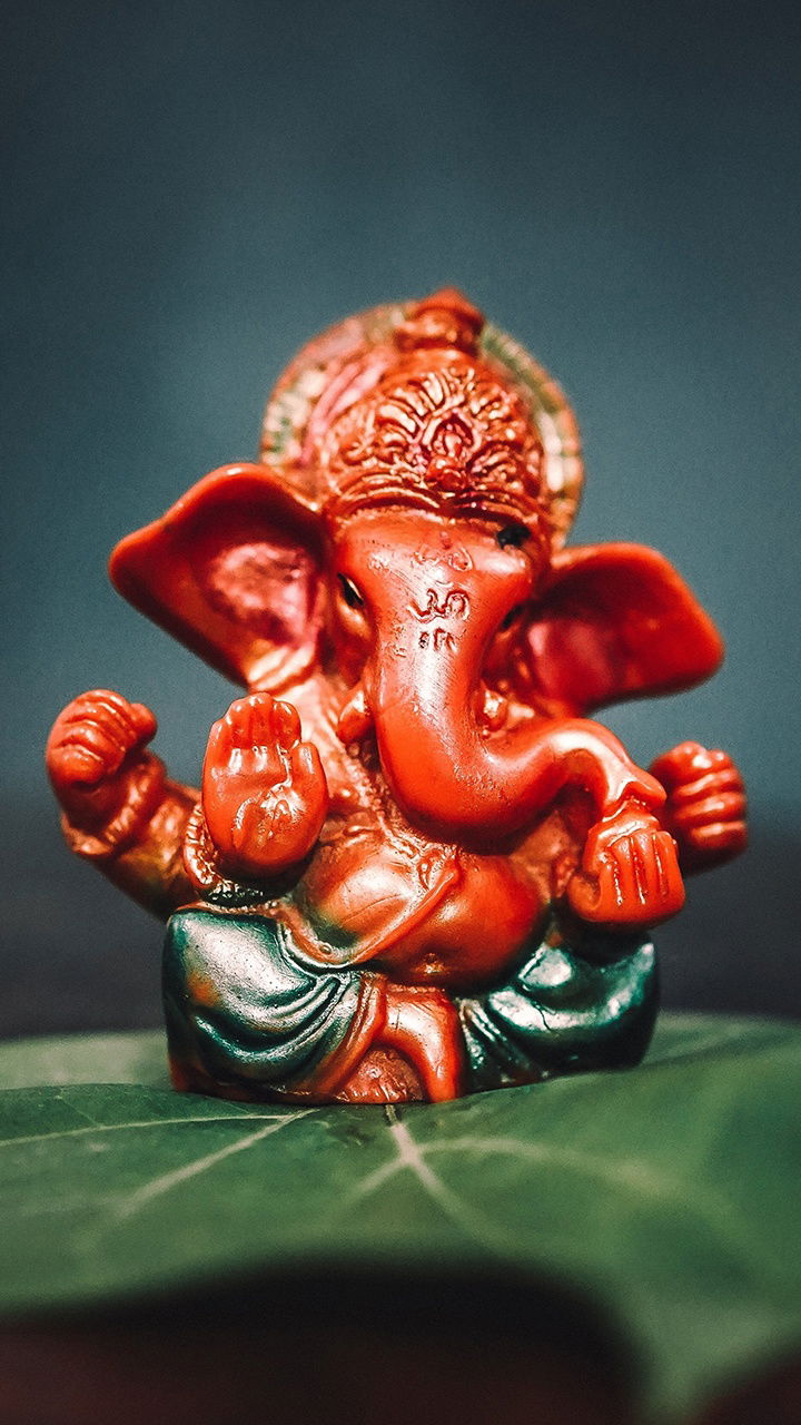 Red Ganesha statue on a leaf