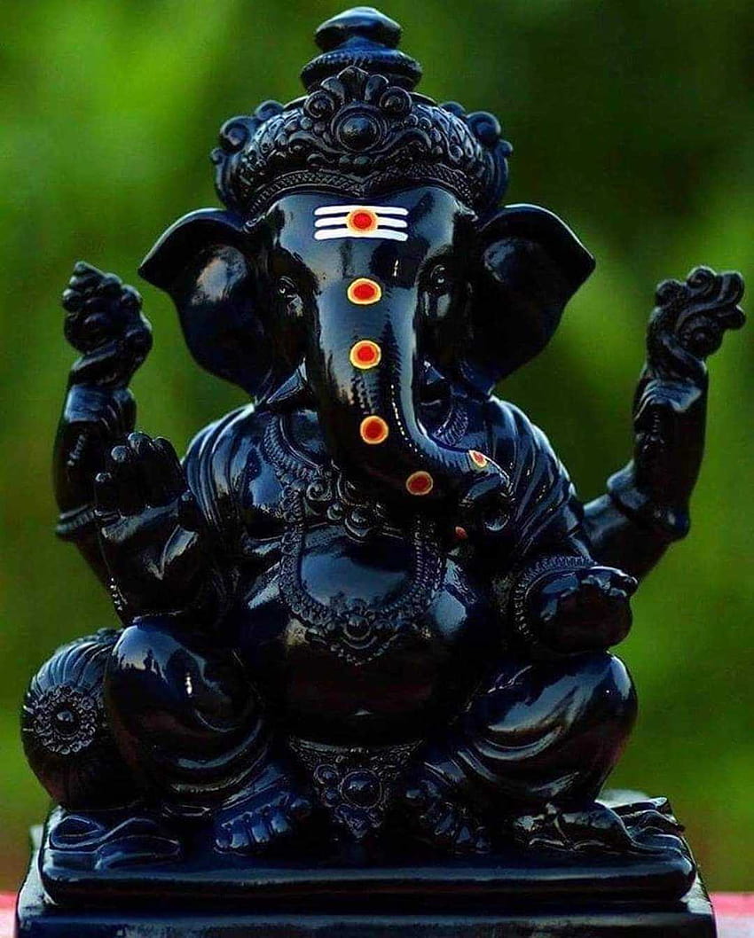 Lord Ganesha statue in dark stone.