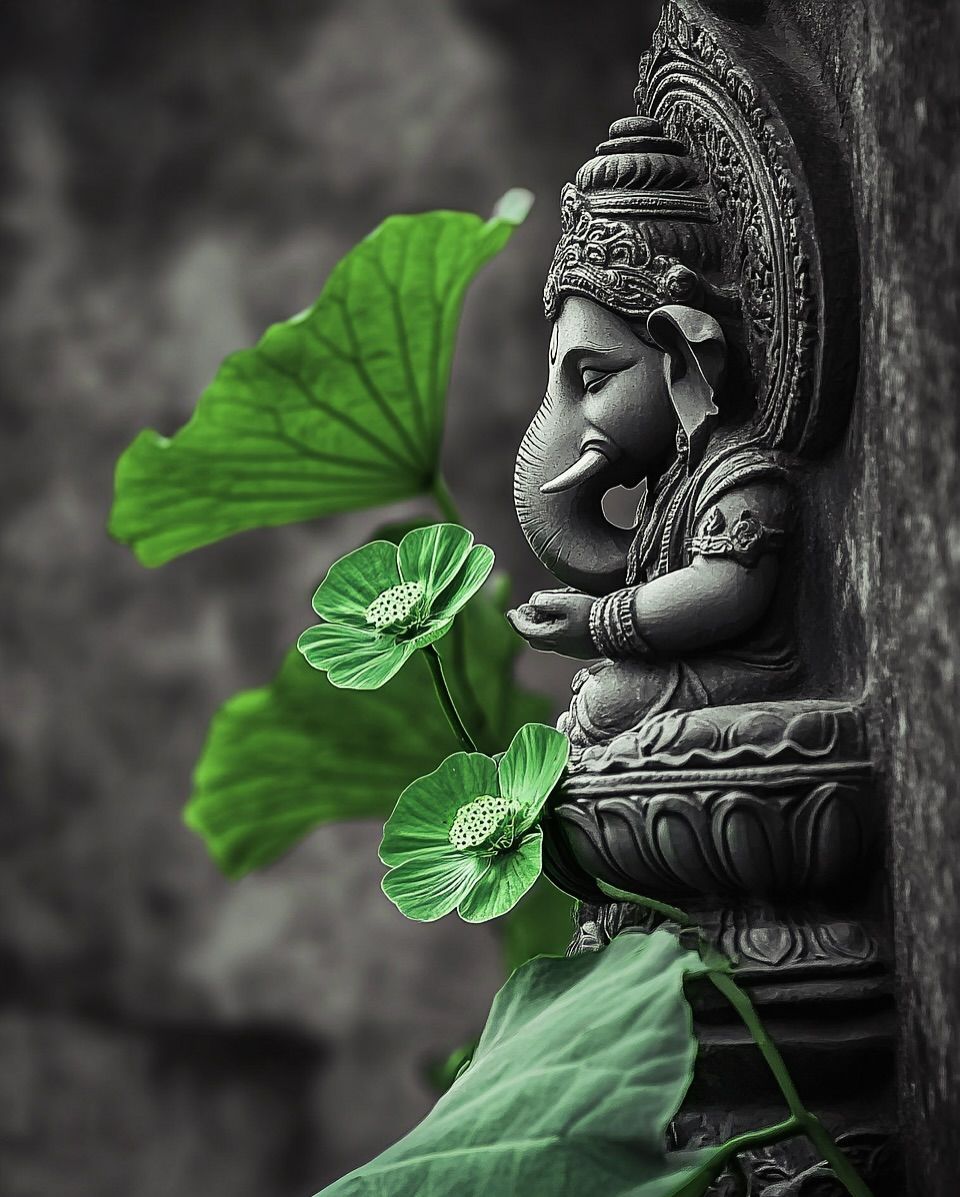 Ganesha statue with green lotus blossoms