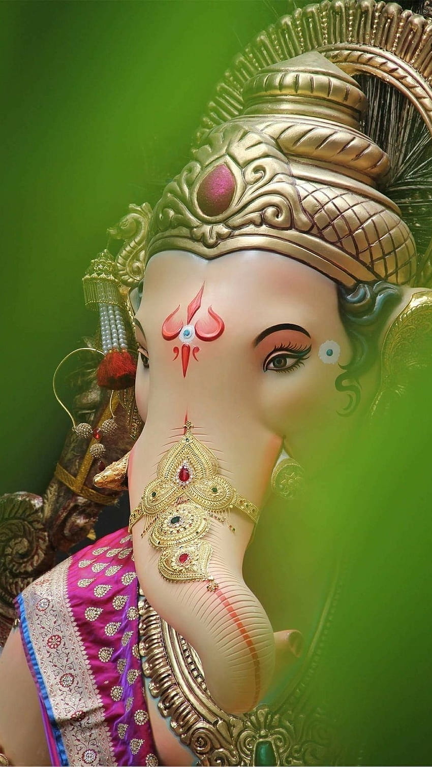 Close-up of Lord Ganesha with gold adornments