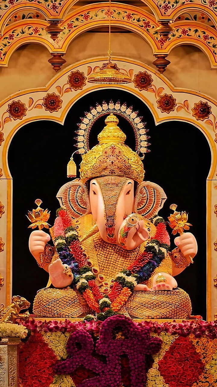 Floral decorated Ganesha idol in temple.