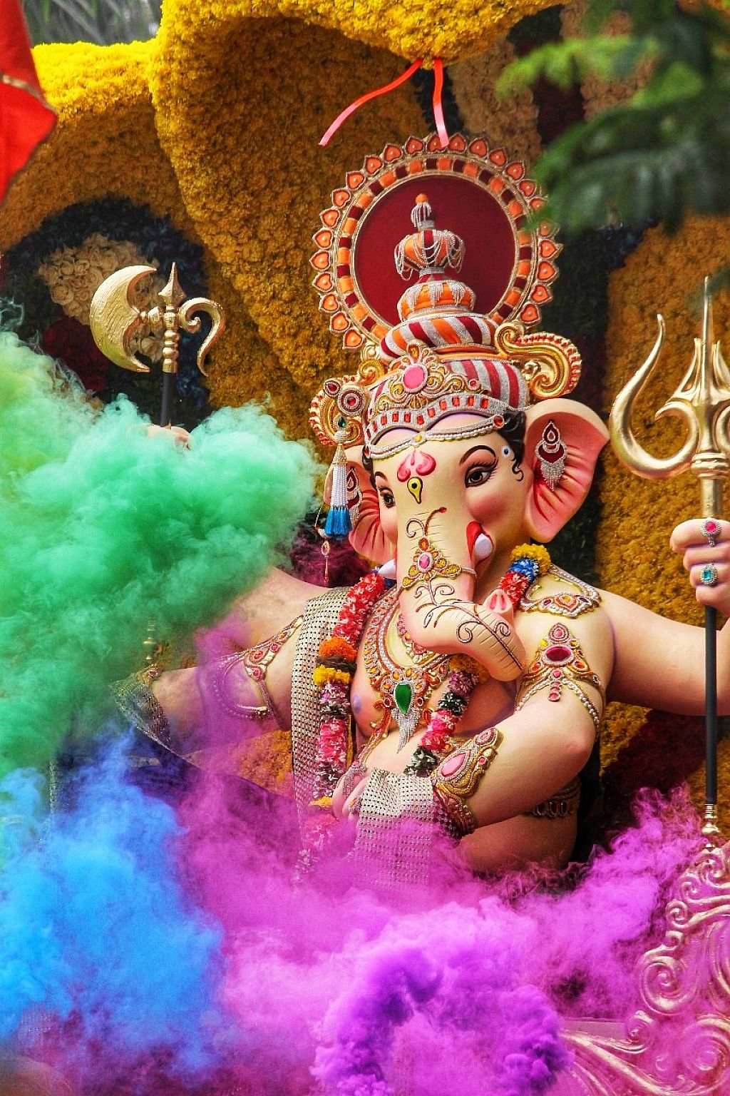Lord Ganesha amidst vibrant floral decorations