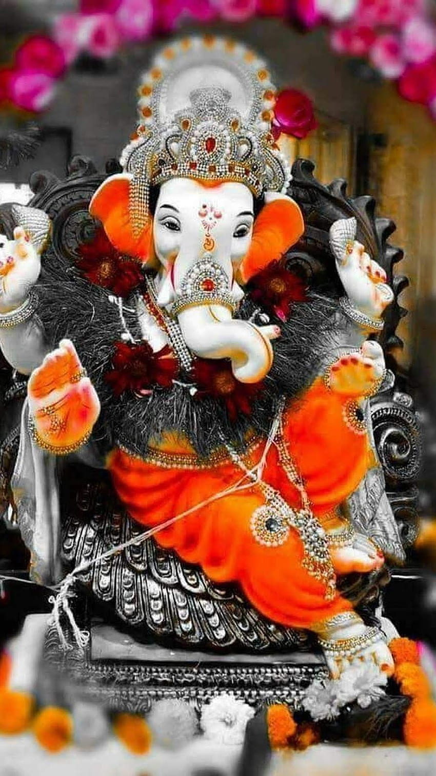 Vibrant Ganesha idol with flowers