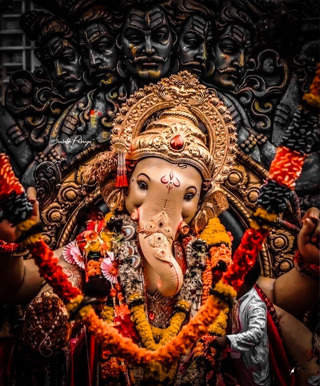 Golden Ganesha with floral decorations.