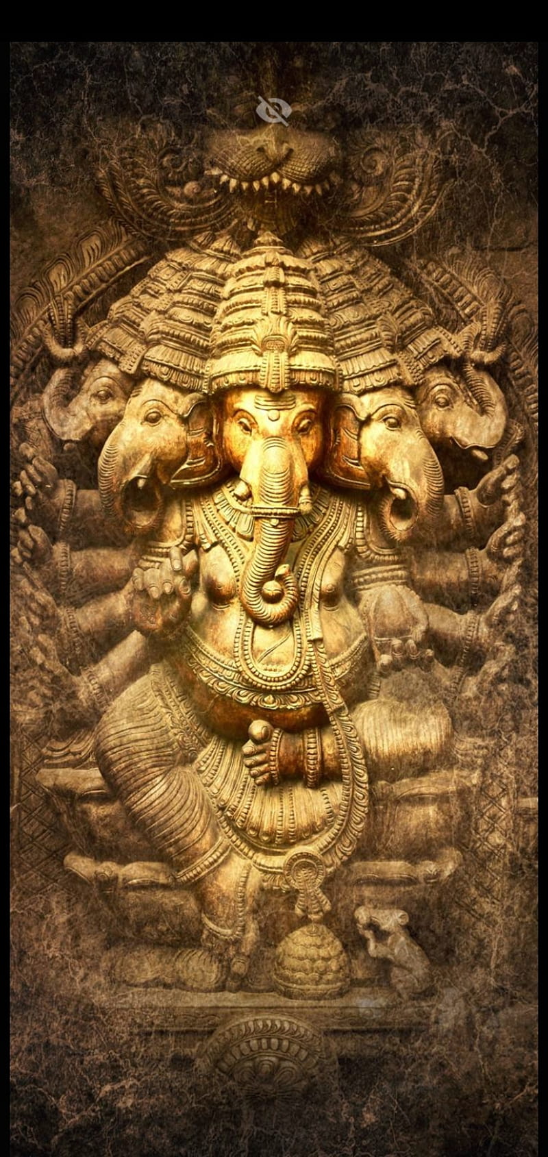 Golden Ganesha sculpture with intricate details