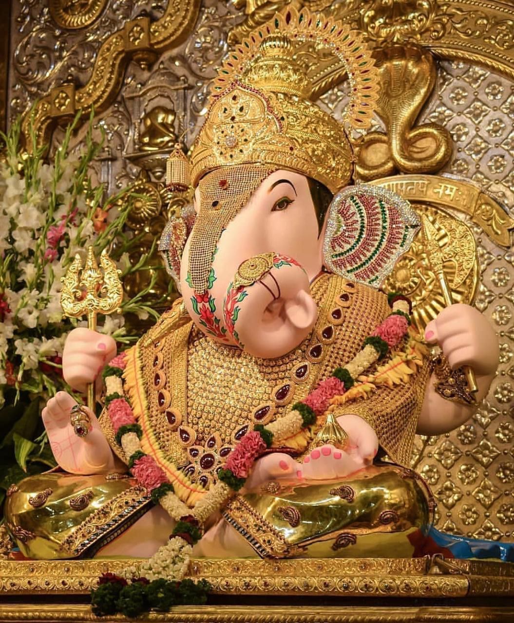 Golden Ganesha with flower garland