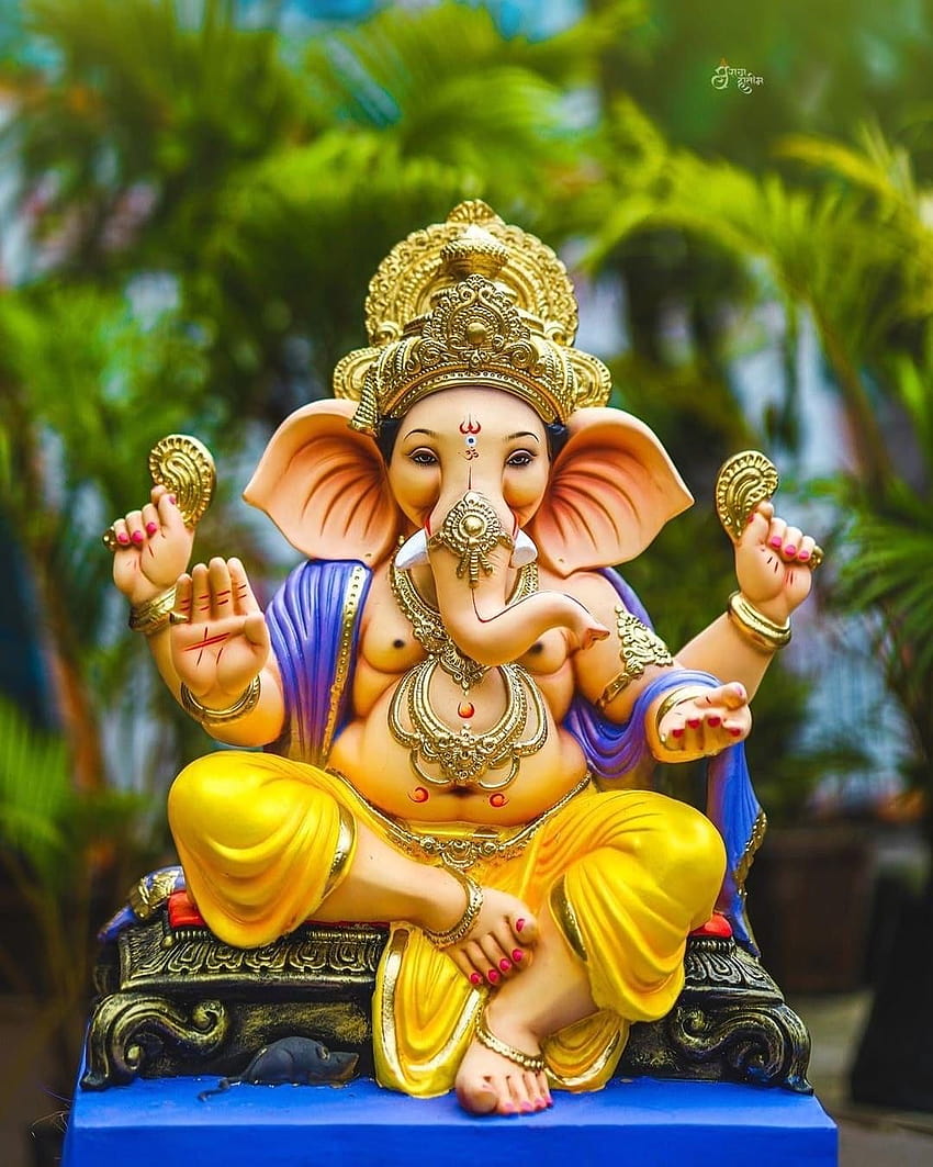 Golden Ganesha statue with modaks
