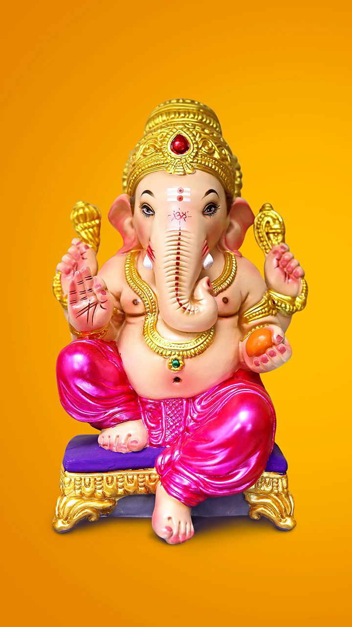 Golden Ganesha statue with modaks