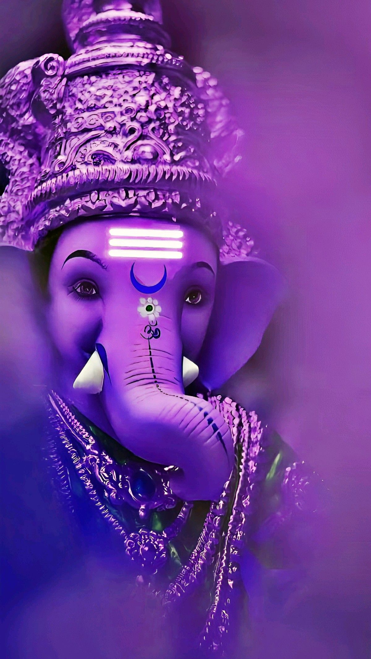 Purple-hued Ganesha idol with intricate details