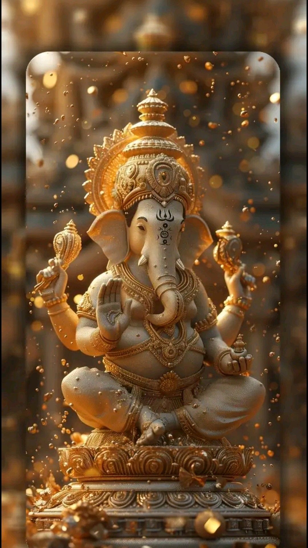 Golden Ganesha idol with modaks