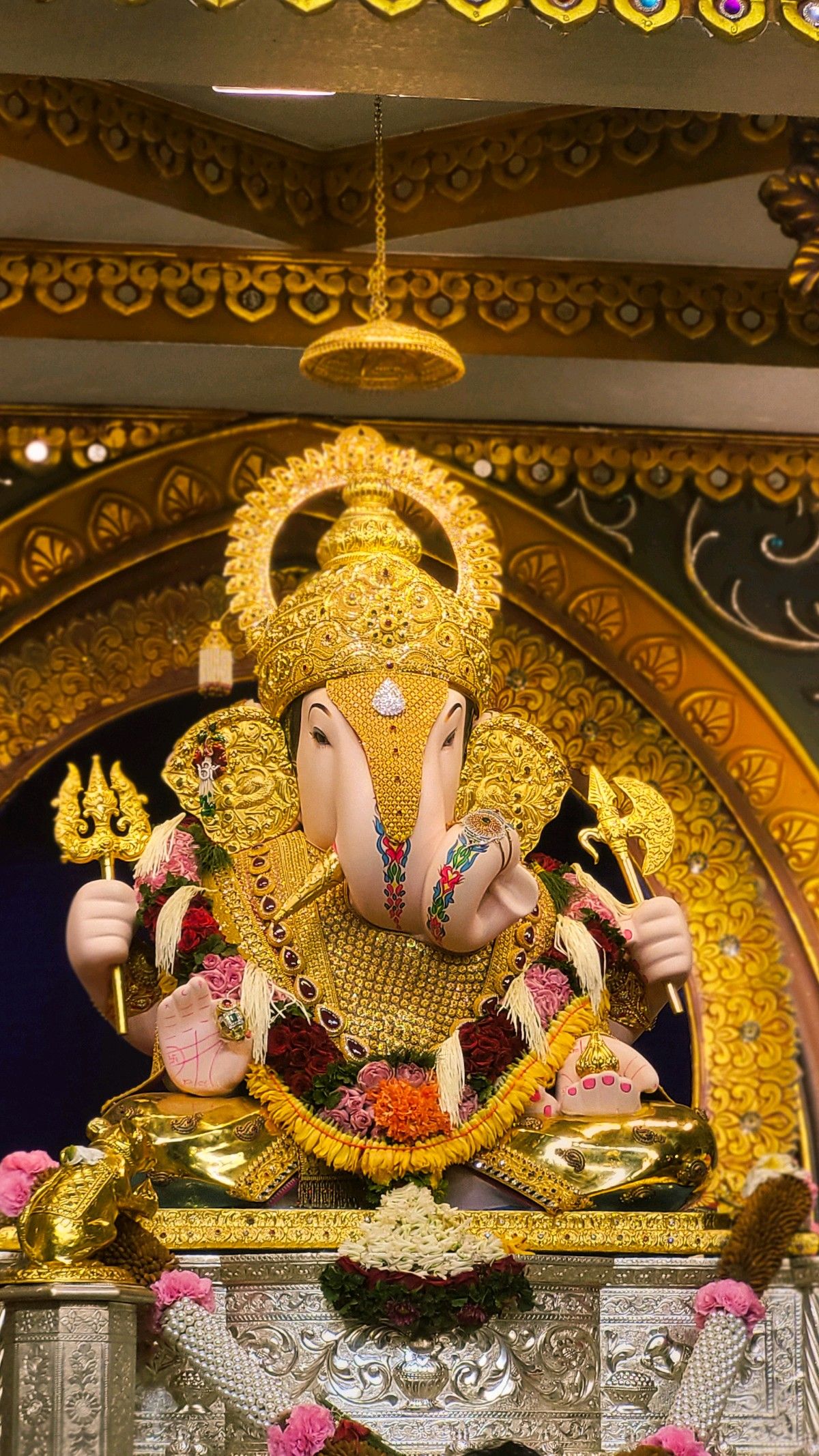Golden Ganesha idol radiating blessings