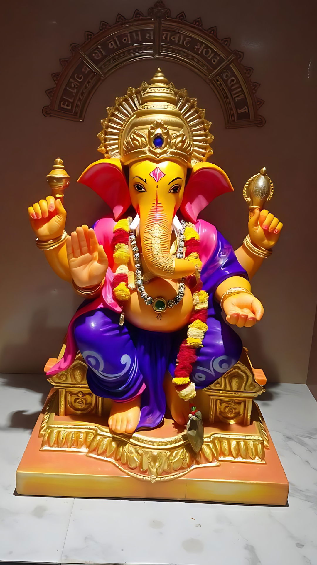 Colourful Ganesha statue with mouse and modak