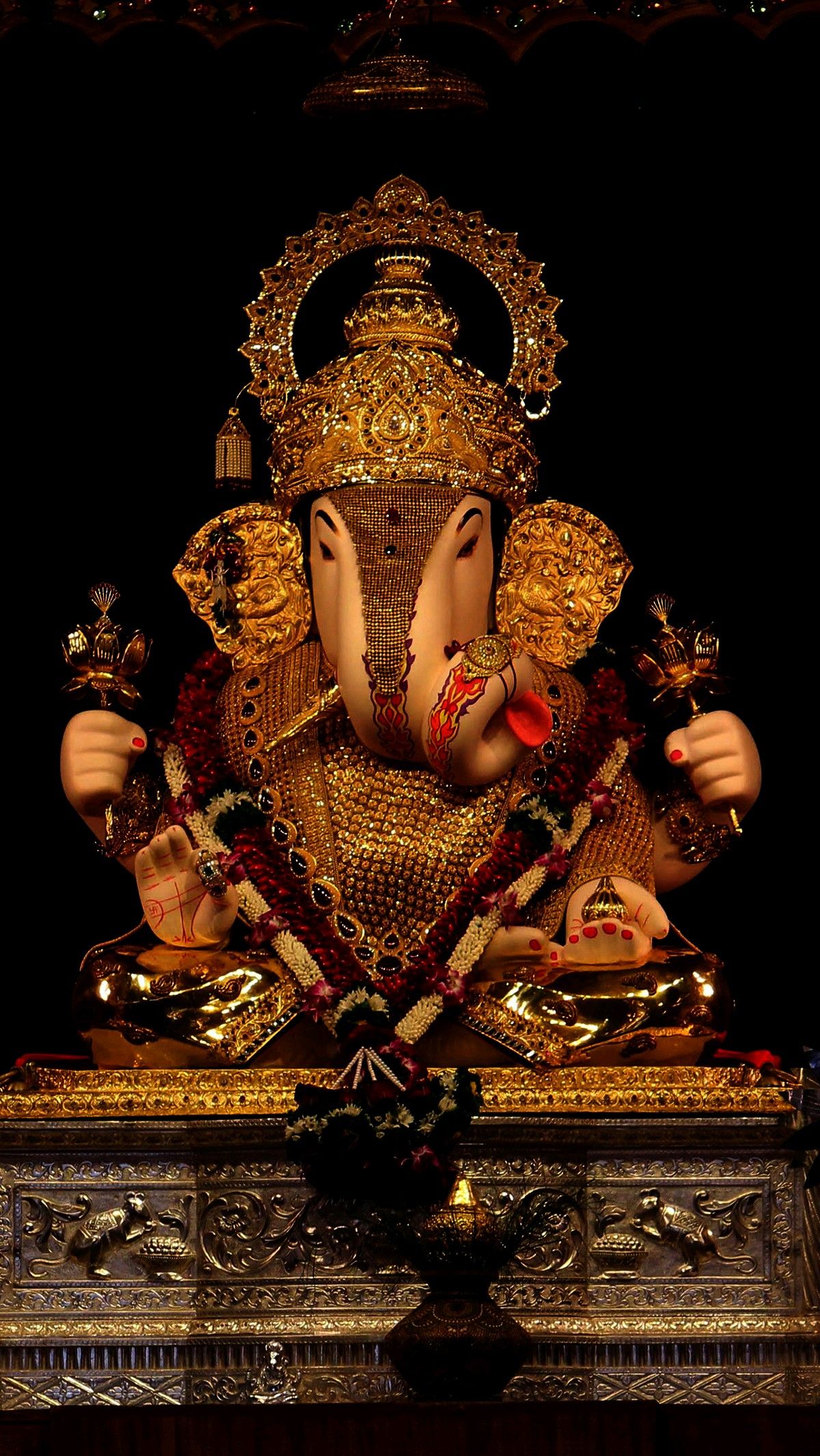 Golden Ganesha idol in temple setting
