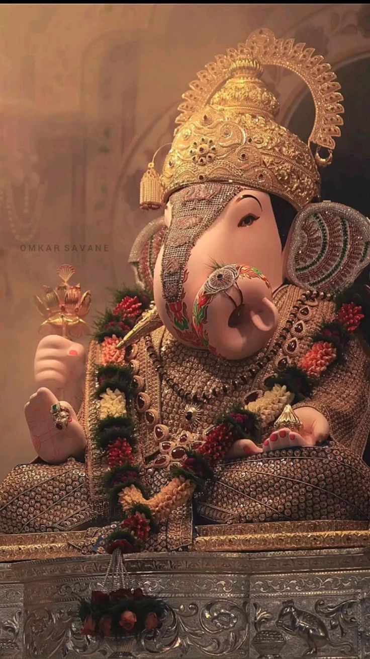 Golden Ganesha adorned with flowers
