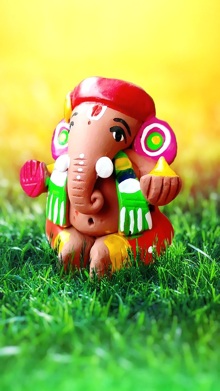 Colorful clay statue of Ganesha in grass