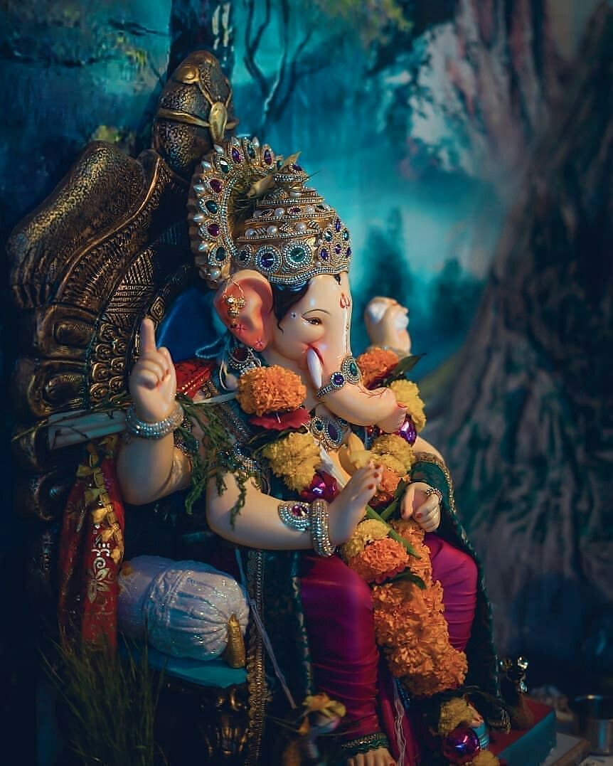 Ganesha adorned with flowers and gold.