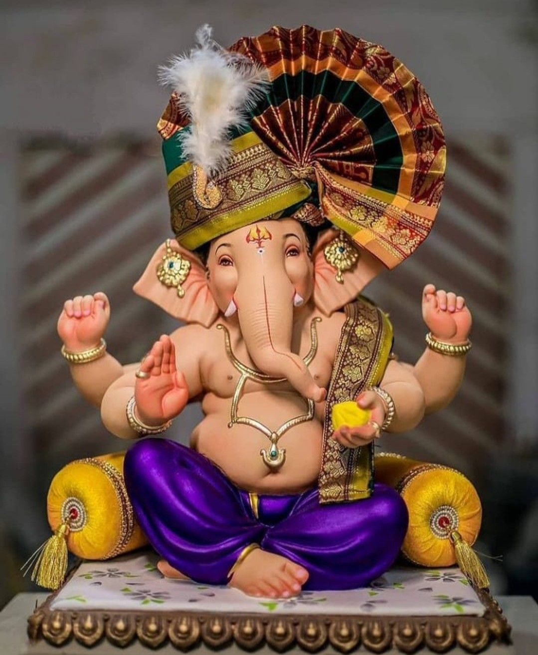 Lord Ganesha in royal attire, blessing devotees.