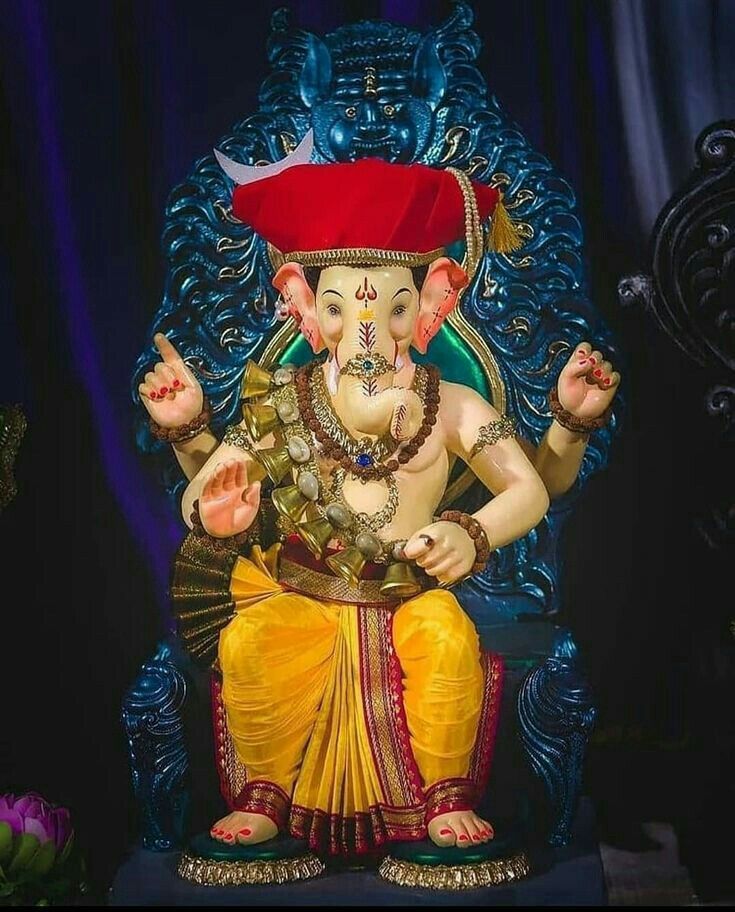 Golden Ganesha idol in regal attire.