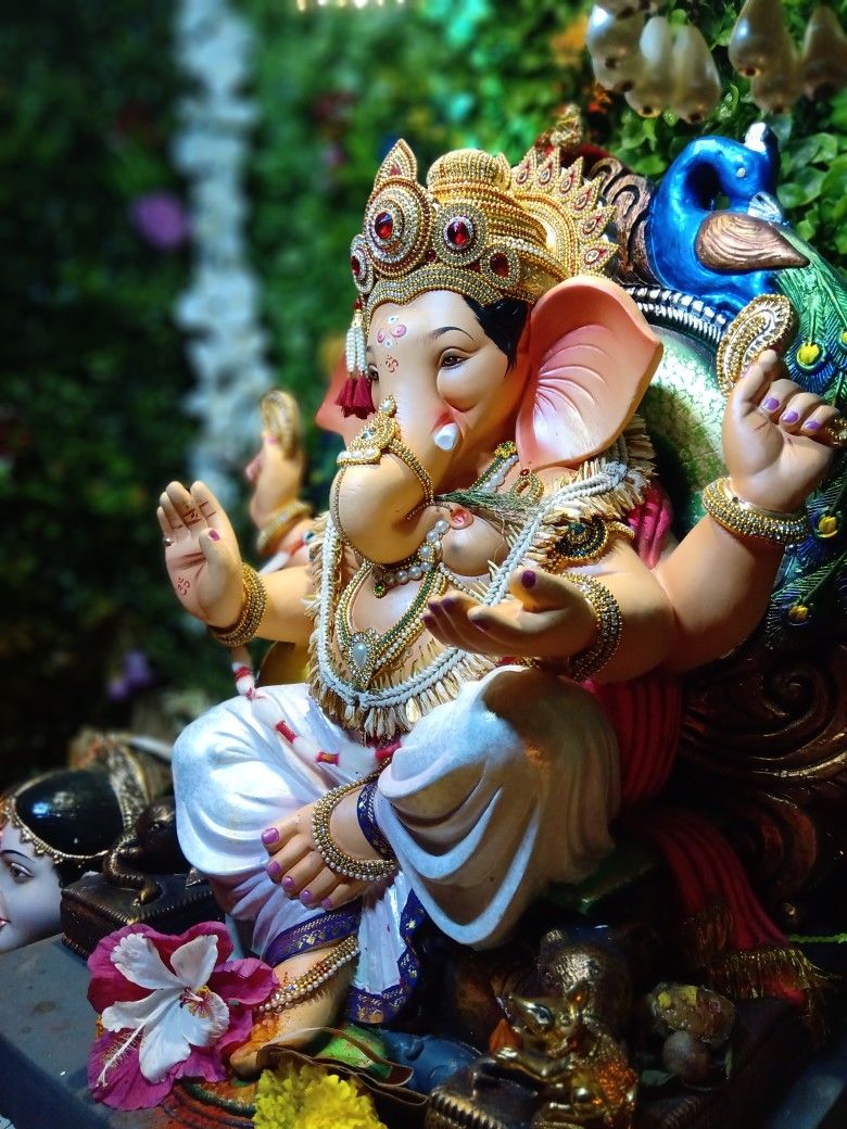 Lord Ganesha with peacock feathers blessing