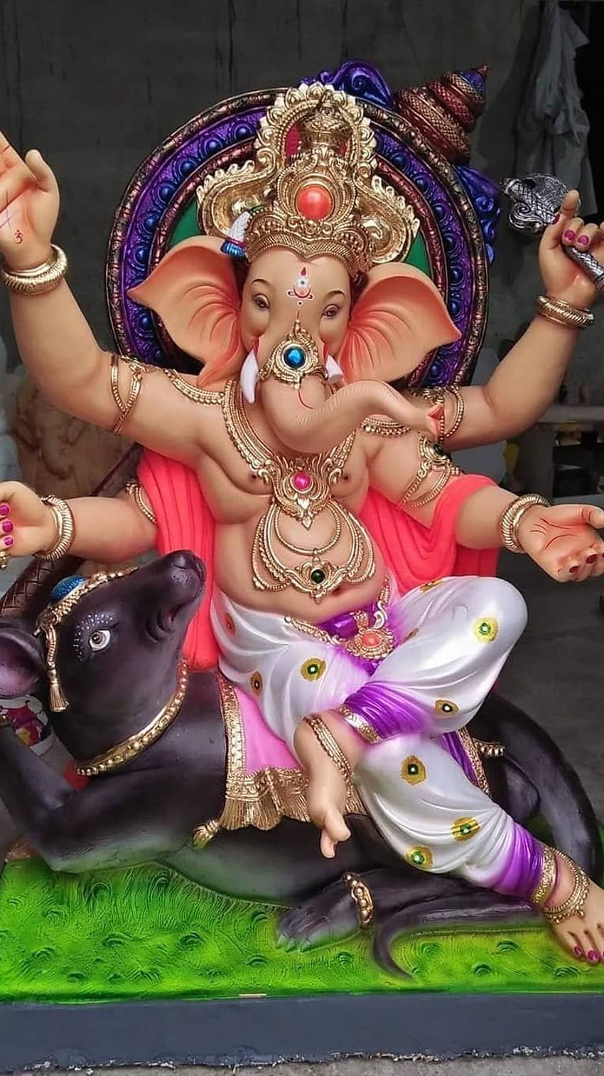 Lord Ganesha seated with mouse and lotus