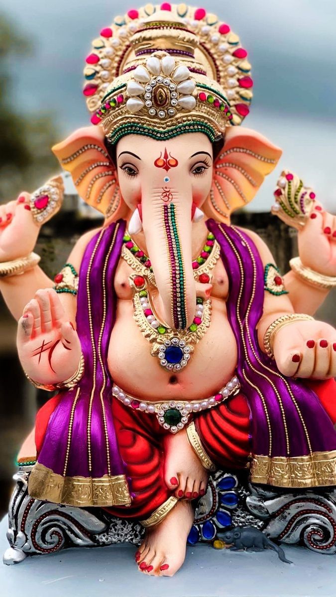 Ornate Ganesha statue with floral crown
