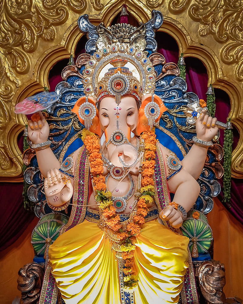Ornate Ganesha statue with modak offering