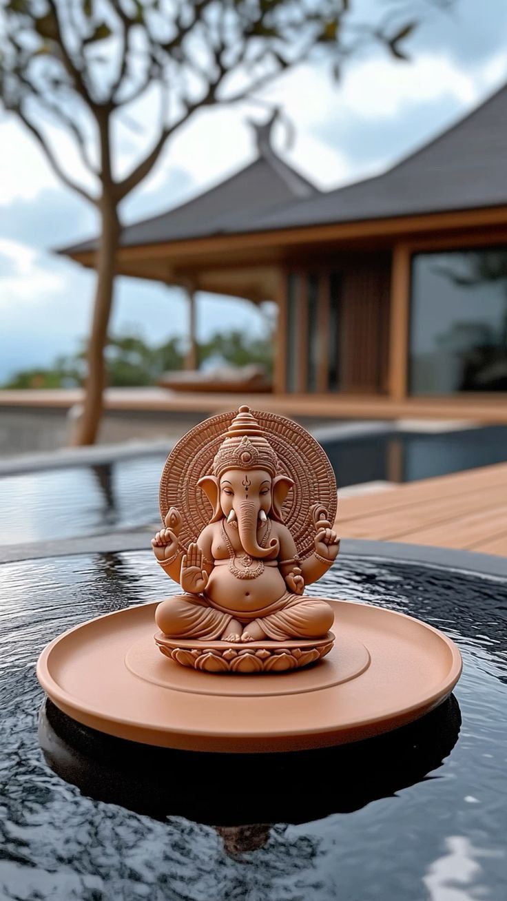Ganesha statue reflecting in a pool