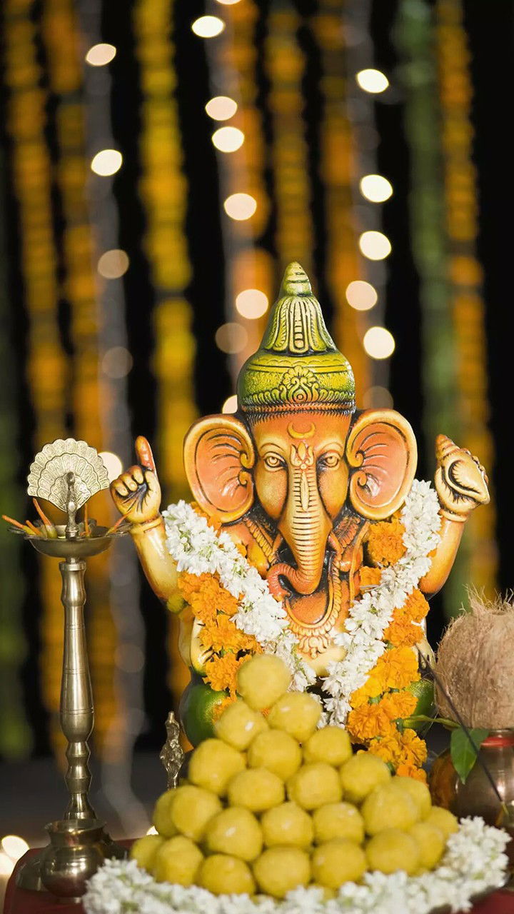 Ganesha with modaks and flowers