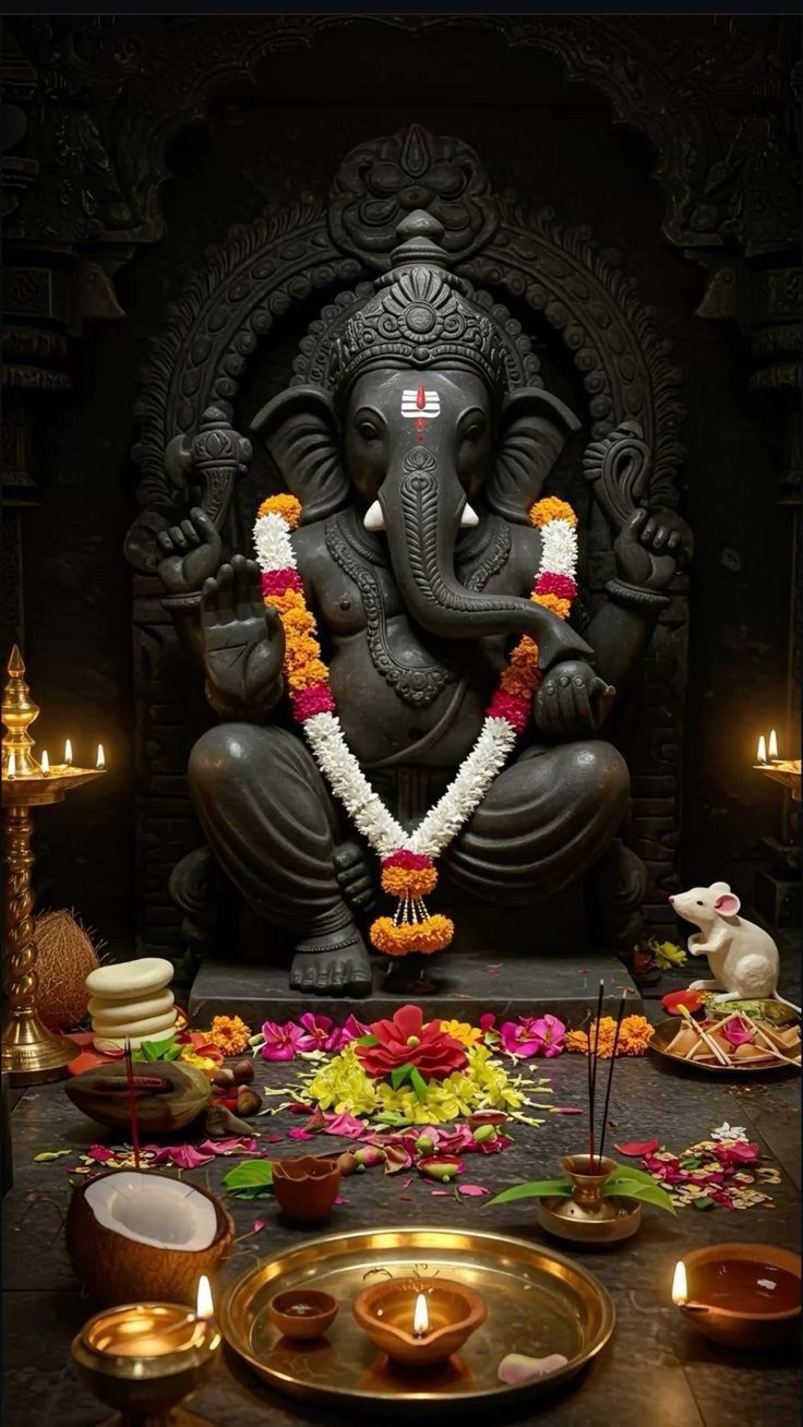 Lord Ganesha with offerings and lamps
