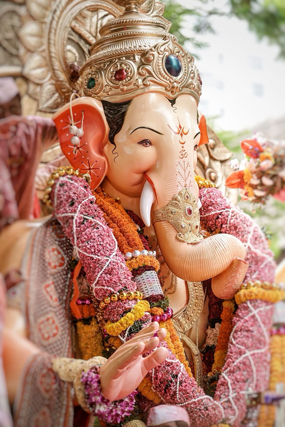 Ganesha adorned with vibrant floral garland